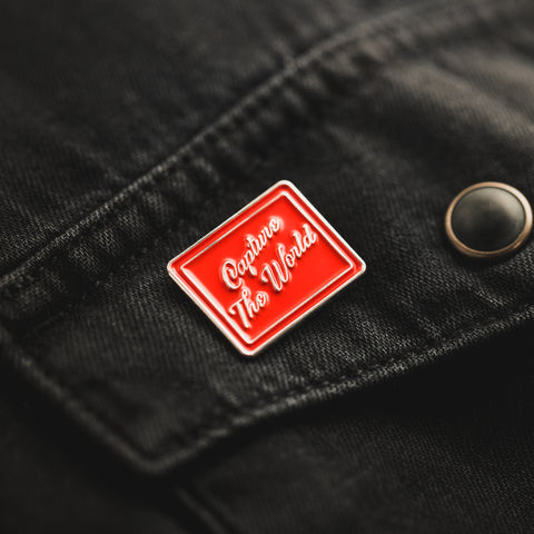 Capture the World Enamel Pin